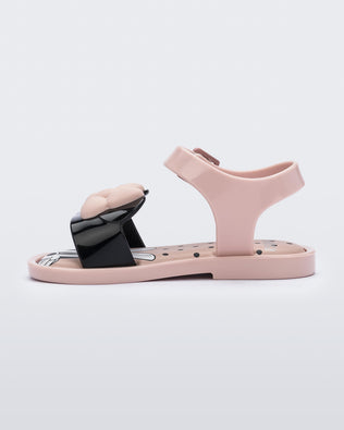 Side view of a pink and black Minnie Mouse Mini Melissa Mar Sandal with a pink bow.