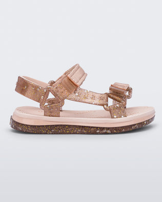 Side view of a pink Mini Melissa Papete with glitter and pink straps.