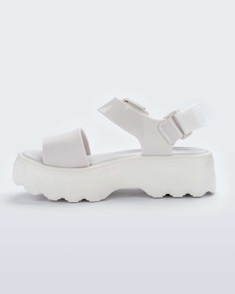 An inner side view of a white Melissa platform Kick Off sandal with two straps.