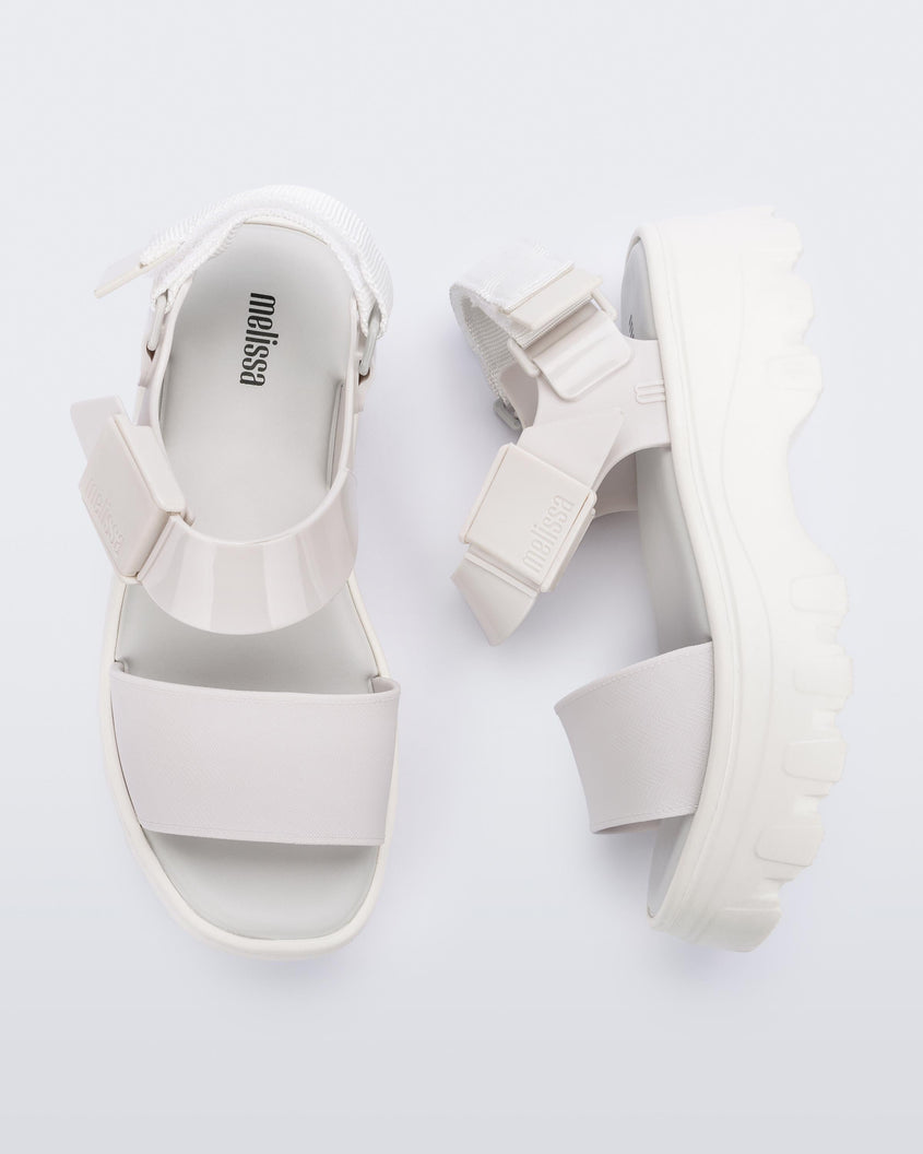 A top and side view of a pair of white platform Melissa Kick Off Sandals with two straps.