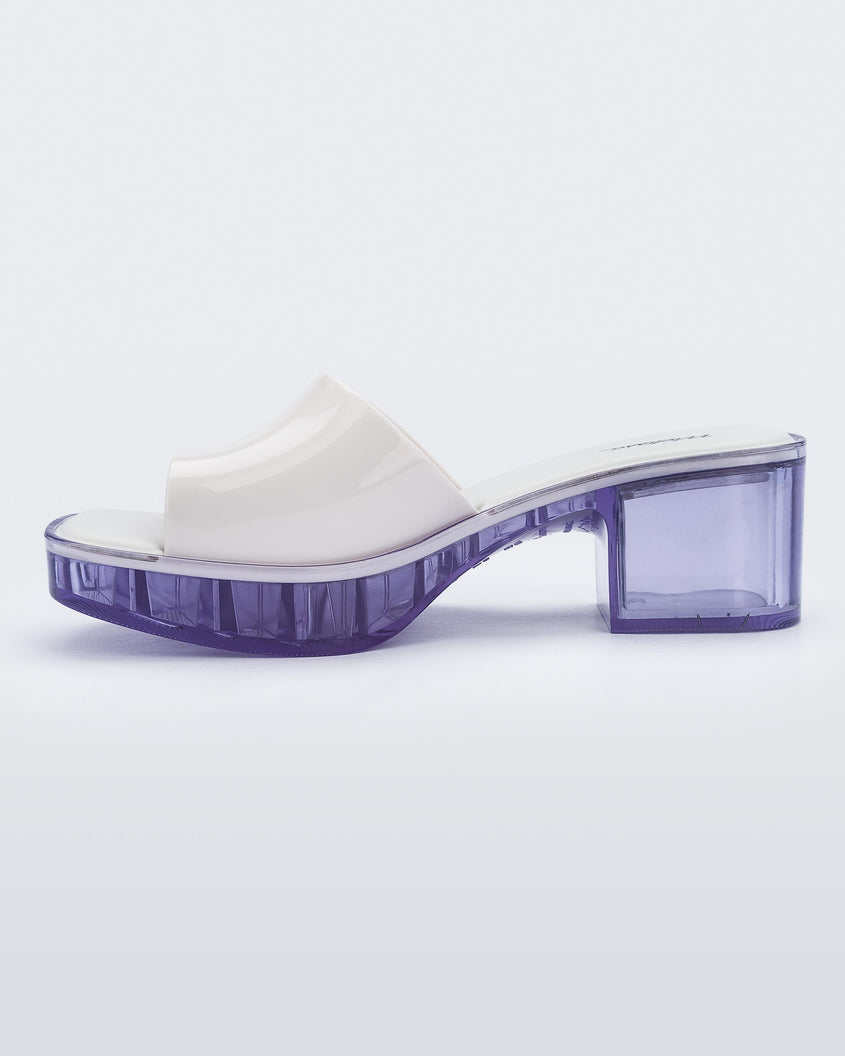 inner side view of a Melissa Shape slide with clear heel and white wide strap 