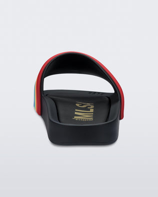 Back view of a black rainbow Melissa Rainbow Beach slide with a black base and a rainbow design on the front strap.