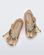 Top view of a pair of gold Mini Melissa Ultragirl Butterfly flats with a top strap and two butterfly details on the toe.