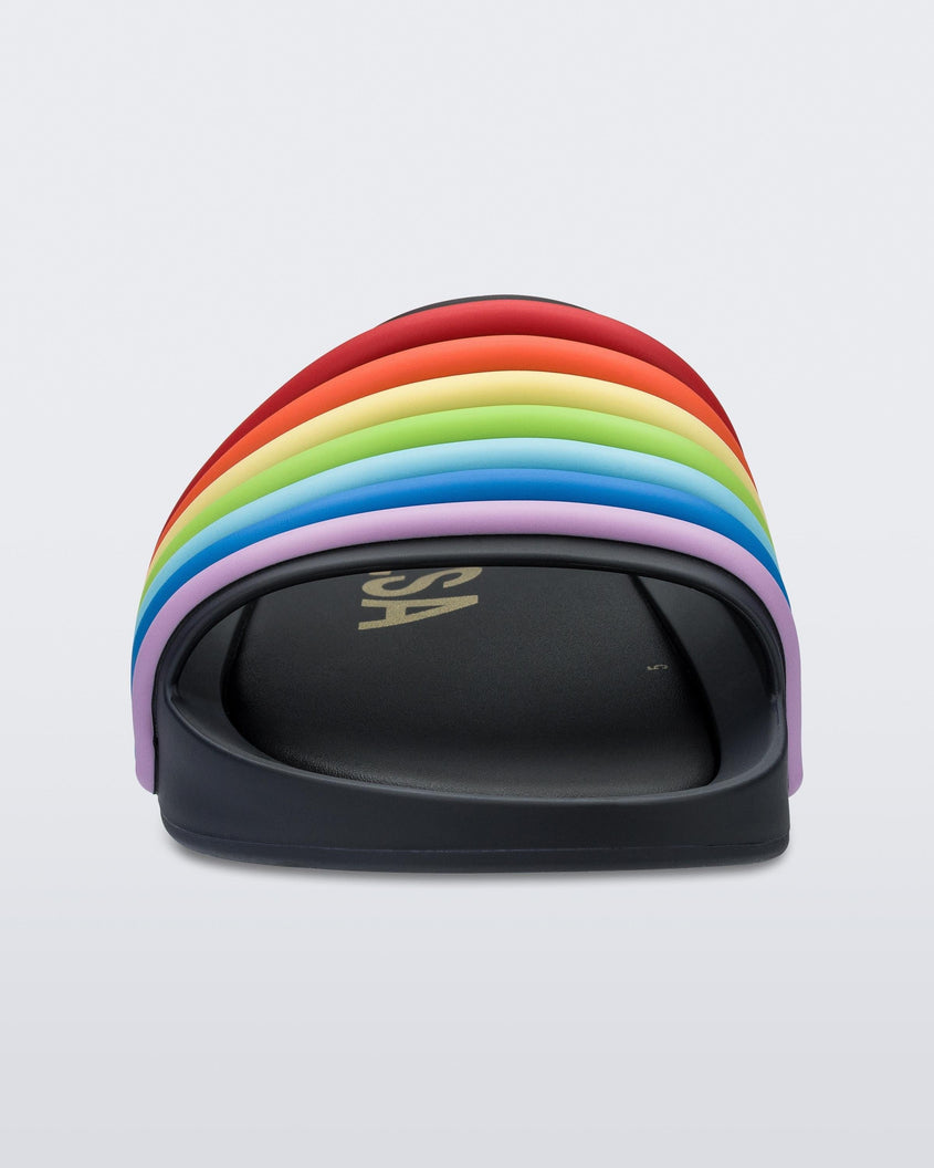 Front view of a black rainbow Melissa Rainbow Beach slide with a black base and a rainbow design on the front strap.