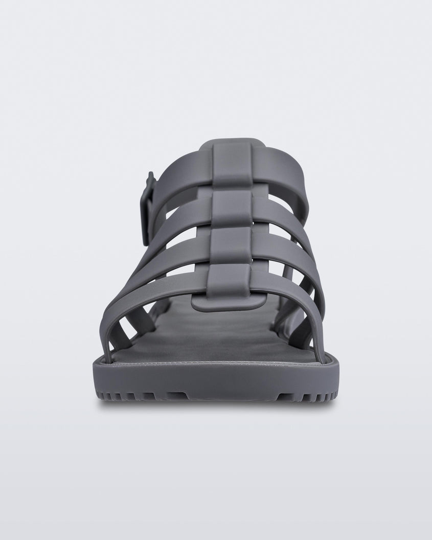 A front view of a dark gray Melissa Flox sandal with straps.