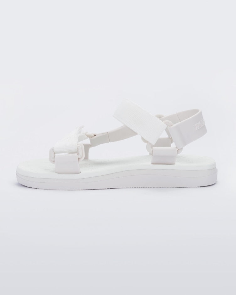 Side view of a pair of white Melissa Papete sandals with straps.
