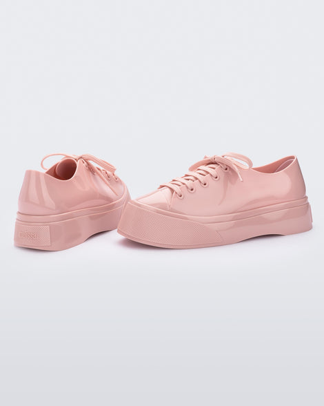 Back and side view of a pair of pink Drive sneaker