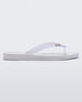 An outter side view of a white/clear Melissa Sun Venice flip flop with a white sole and clear straps with 