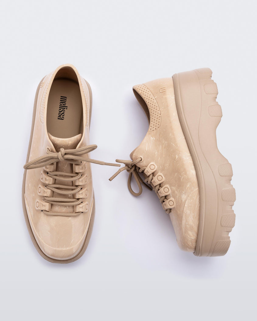 A top and side view of a pair of beige platform Melissa Kick Off Sneakers with laces.