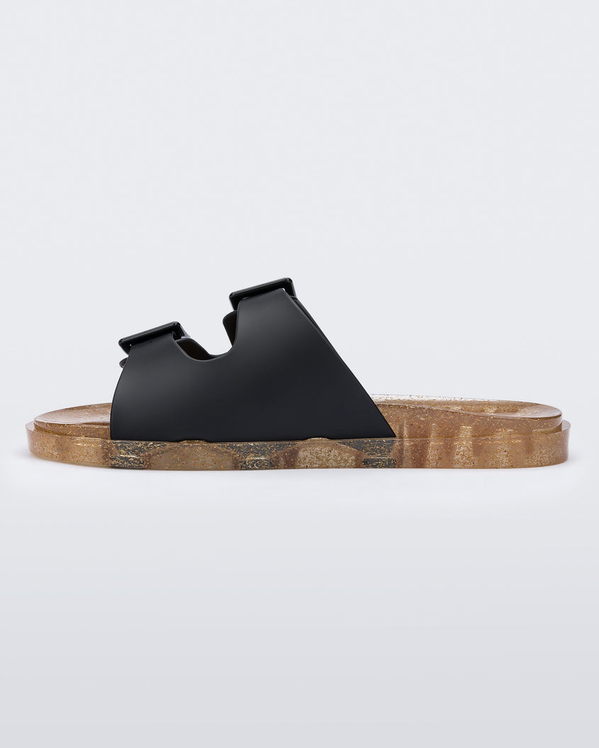 Inner side view of a Melissa Wide Slide sandal with gold speckled sole and two black front straps