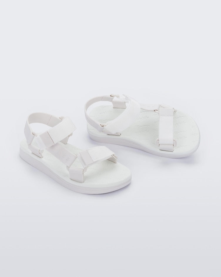 Angled view of a pair of white Melissa Papete sandals.