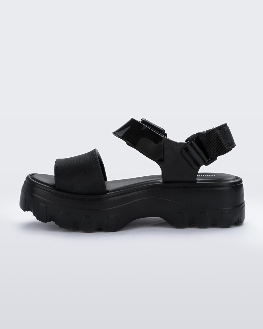 An inner side view of a black Melissa platform Kick Off sandal with two straps.