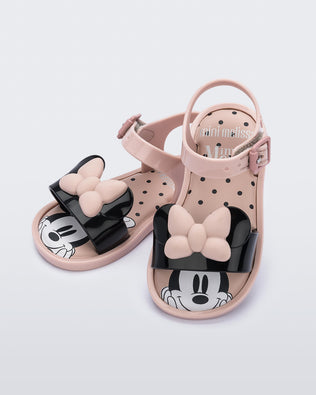 Aangled view of a pair of Mini Melissa Mar sandals in pink with Minnie Mouse on them.