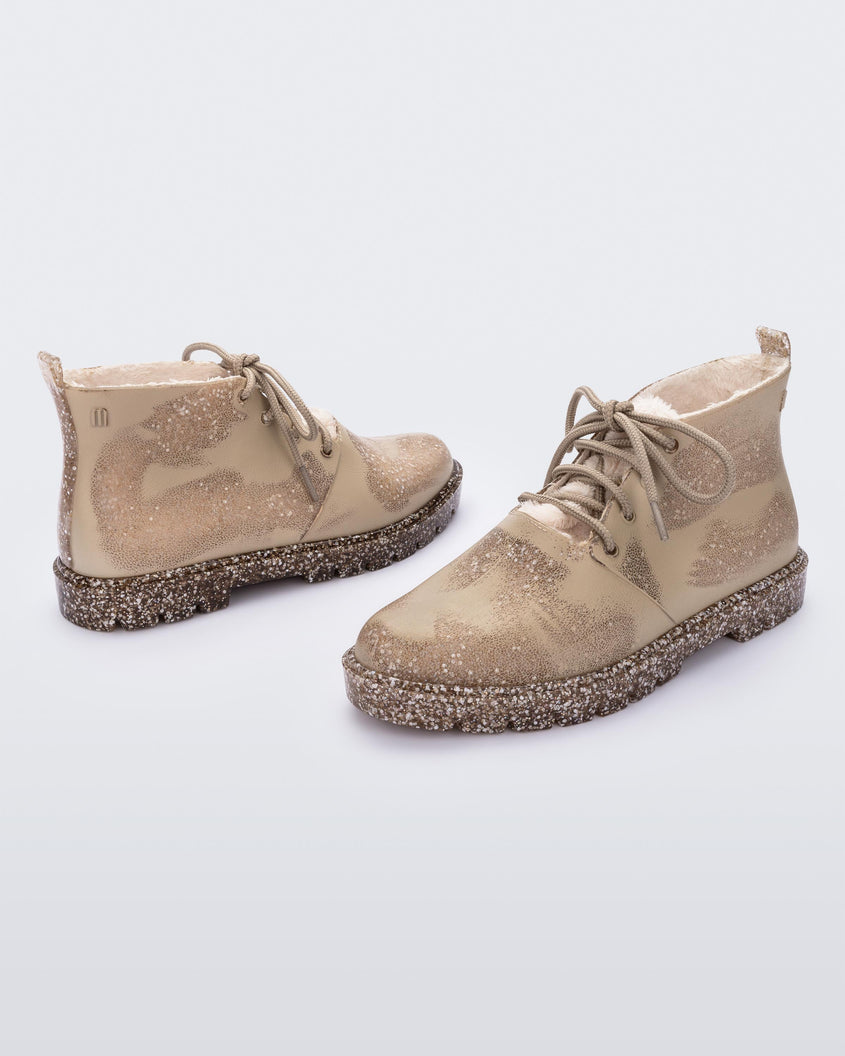 Side view of a pair of Beige Flecked/Glitter Melissa Fluffy Boots with laces and a rubber sole.