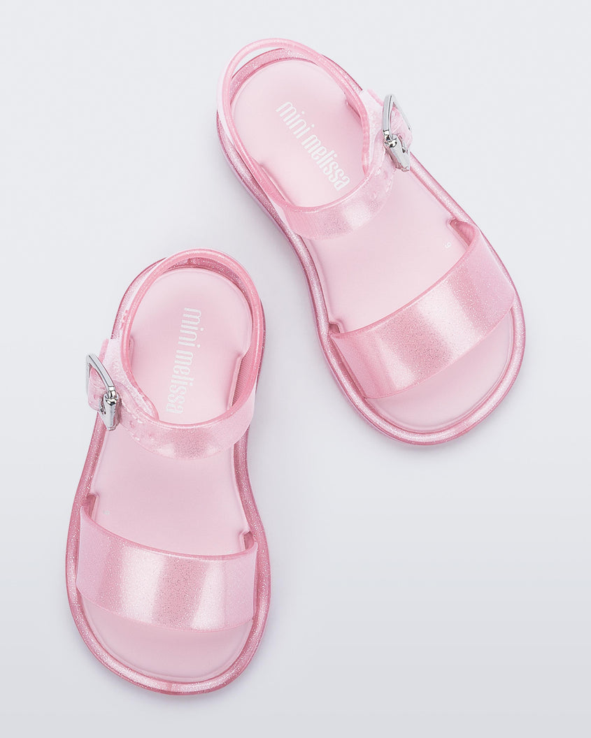 Top view of a pair of pink glitter Mini Melissa Mar Sandal with two straps.