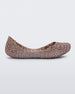 An outter side view of a pink metallic Mini Melissa Campana flat with a woven design base.