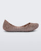 An outter side view of a pink metallic Mini Melissa Campana flat with a woven design base.
