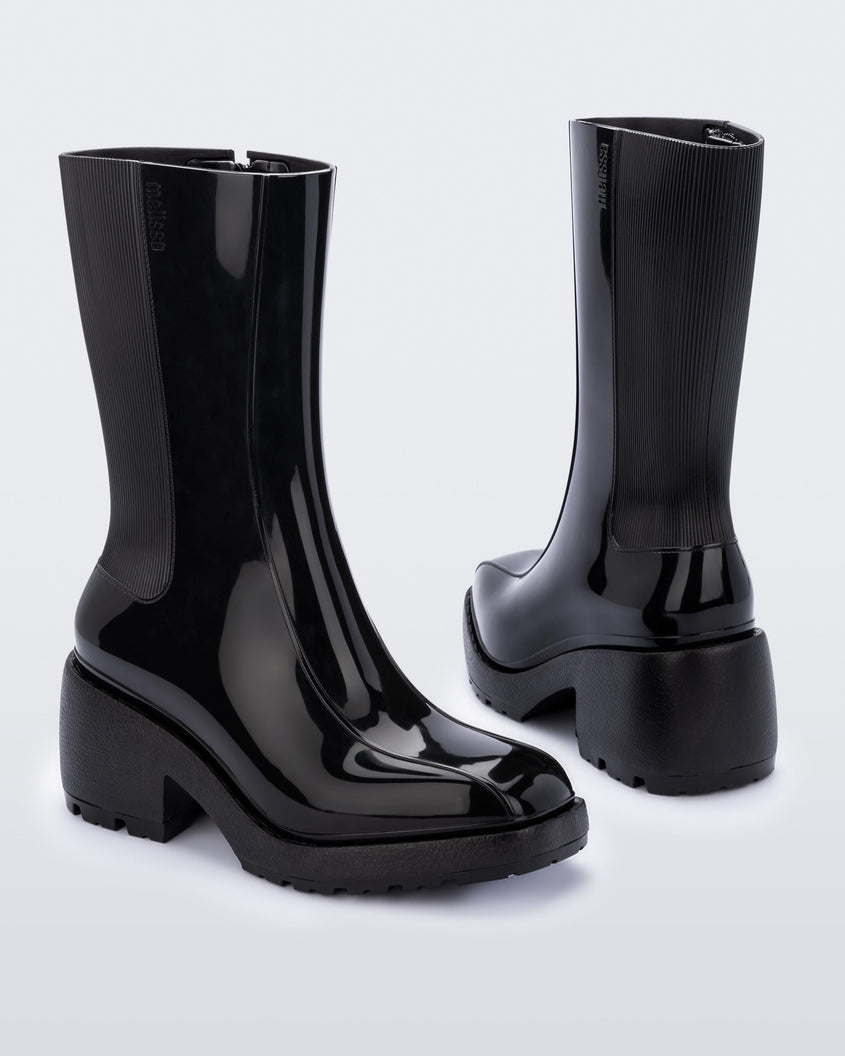 Front and back angled view of a pair of Melissa Nancy heeled boots in black, with calf height shaft. 