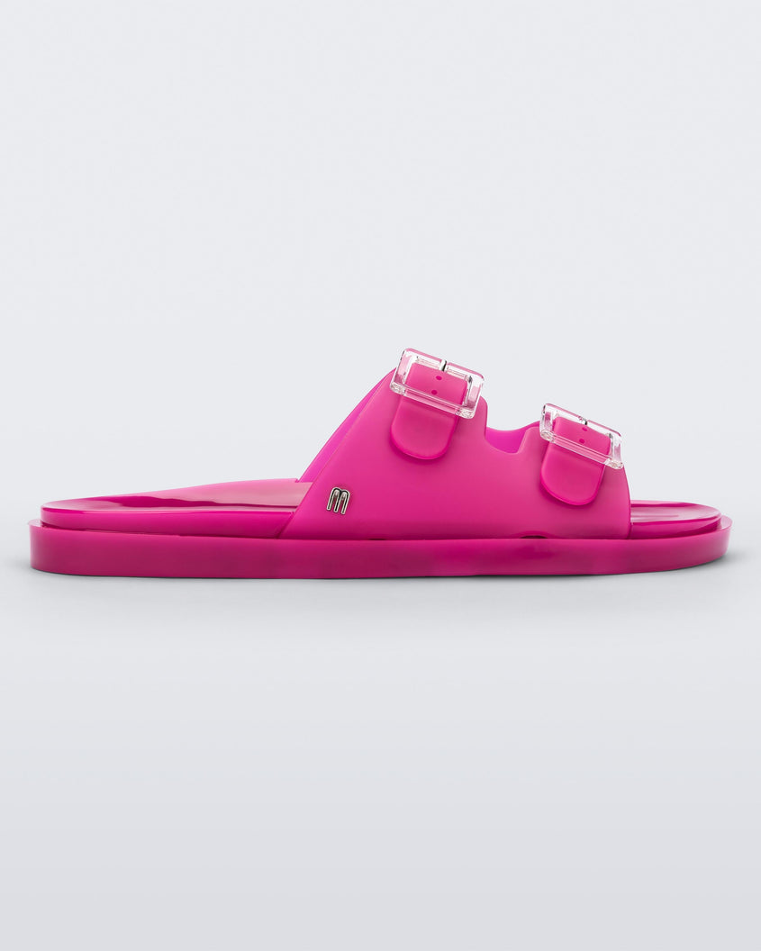 Side view of a dark pink Melissa Wide Slide with two straps fastened at the top with two clear buckles.
