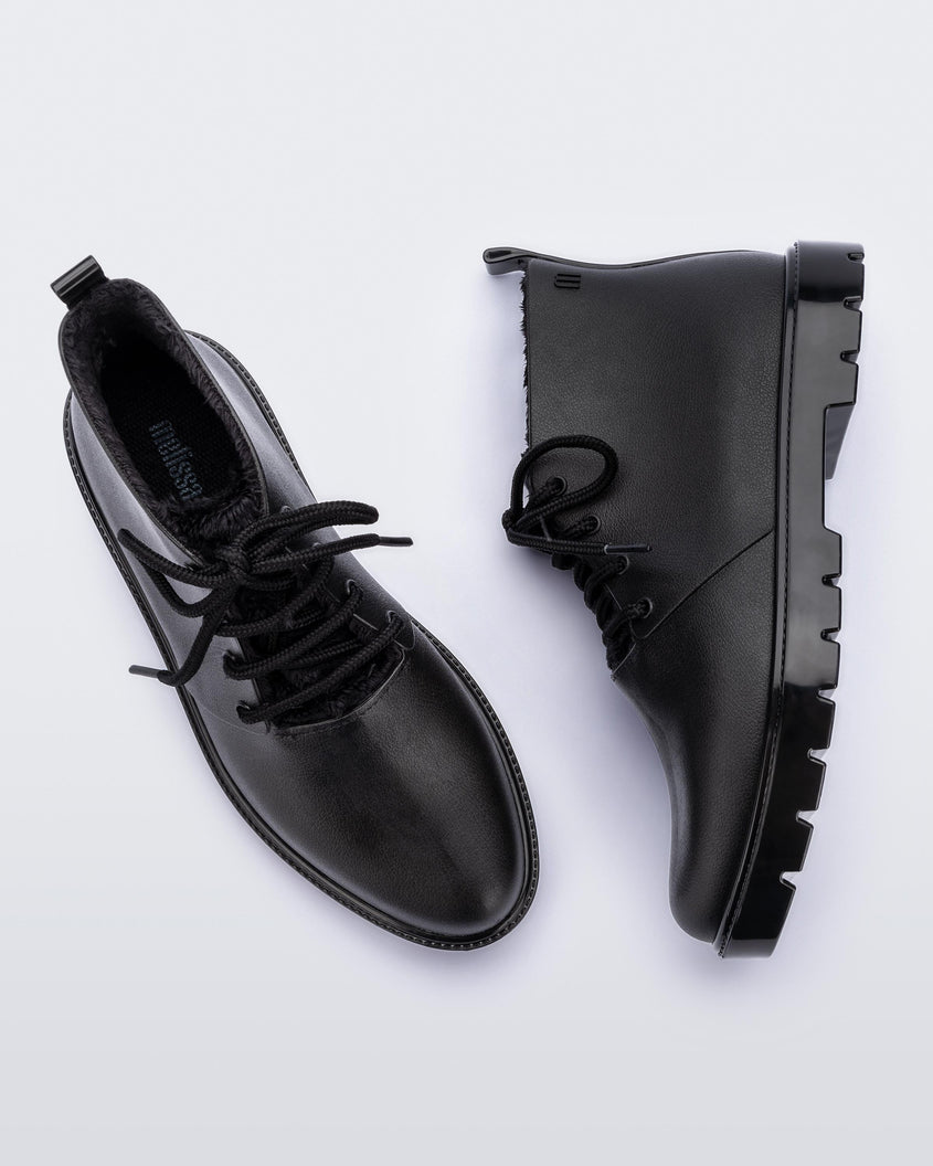 A top and side view of a pair of black Melissa Fluffy Boots with laces and a rubber sole.
