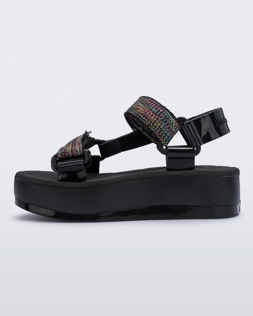 An inner side view of a black Melissa Papete Platform sandal with a black multicolor straps.