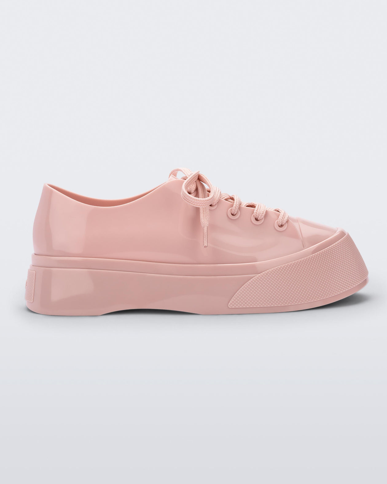 Side view of a pink Drive sneaker