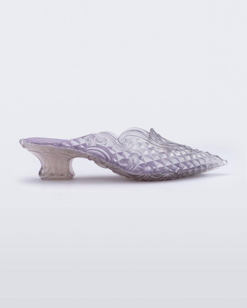 Side view of a Melissa Court mule in clear with a kitten heel and diamond- like pattern. 