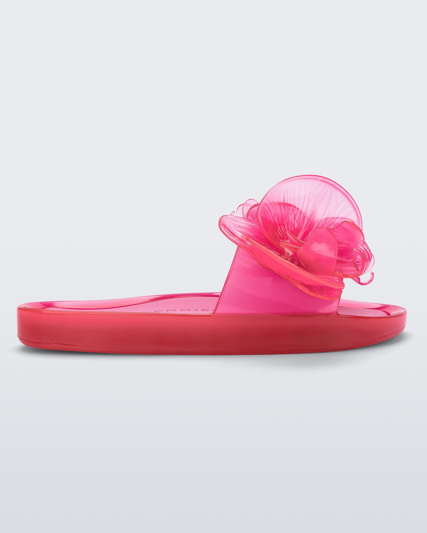 Side view of a pink Melissa Flower Beach slide with flowers on the top.