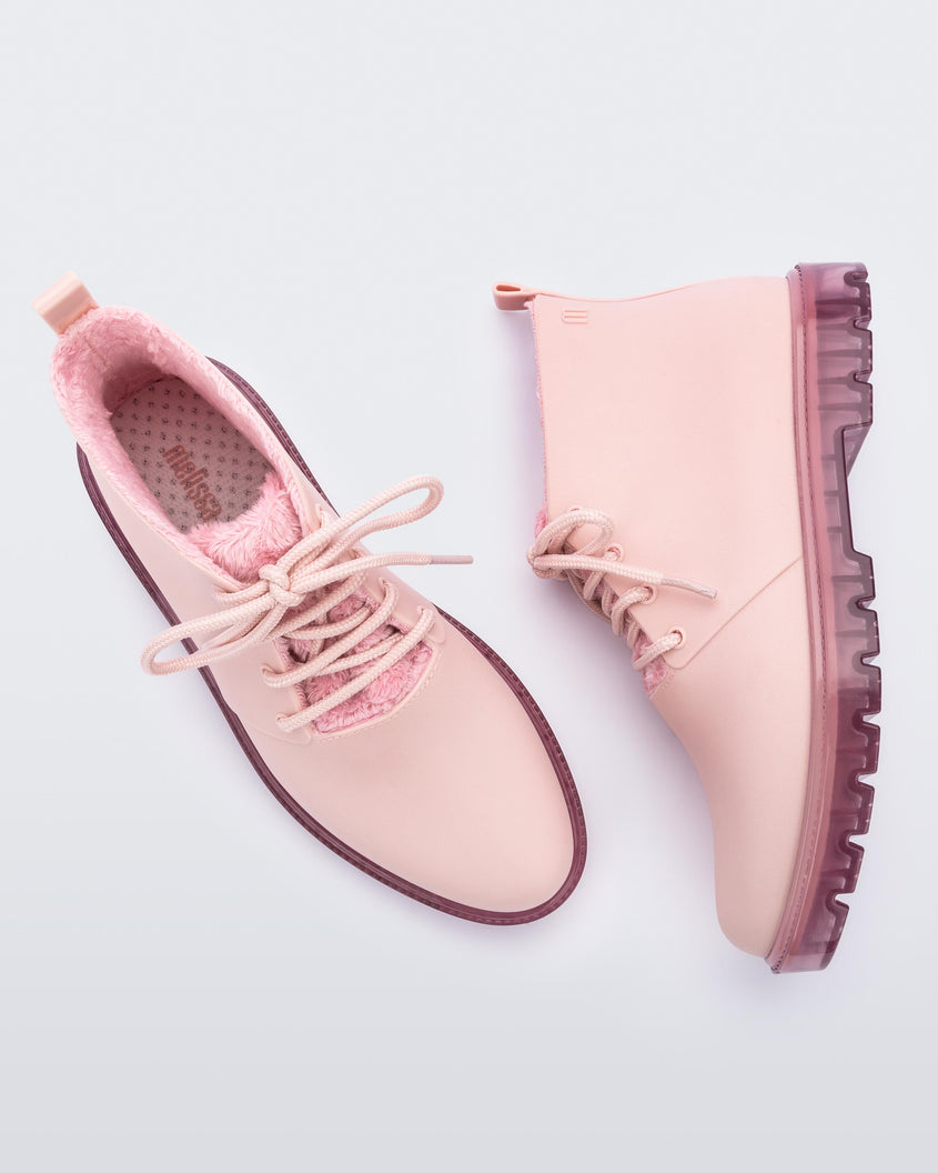 A top and side view of a pair of pink Melissa Fluffy Boots with laces and a rubber sole.