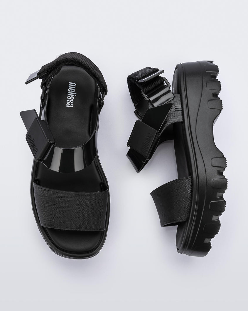 A top and side view of a pair of black platform Melissa Kick Off Sandals with two straps.