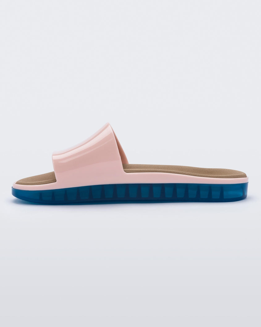 Inside view of a pink Melissa Beach slide with blue sole. 