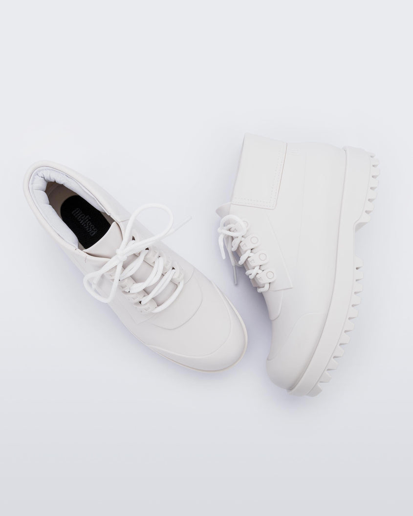 A top and side view of a pair of matte white Melissa Ares combat boot with a matte white base, laces, top back and sole.