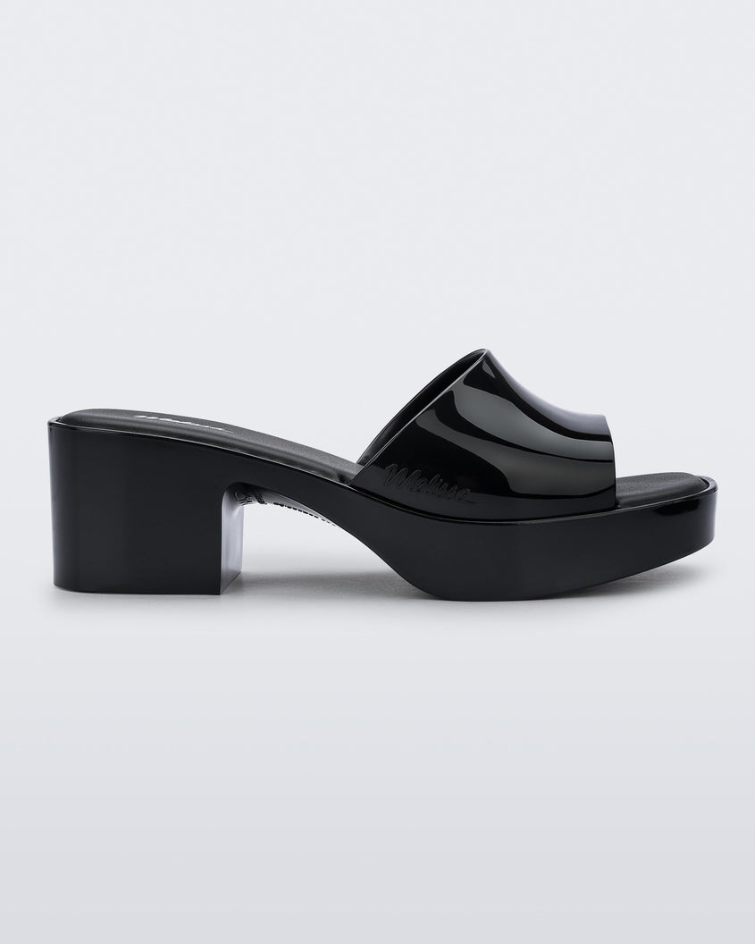 Side view of Melissa Shape slide in black, with a platform heel. 