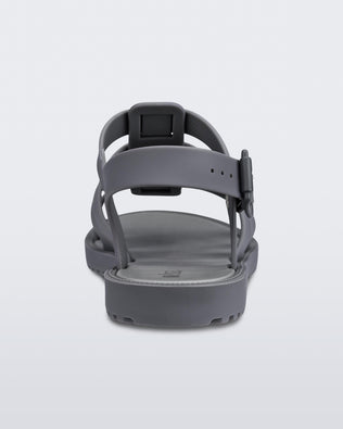 A back view of a dark gray Melissa Flox sandal with straps.