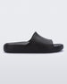 Side view of a matte black Melissa Cloud slide.