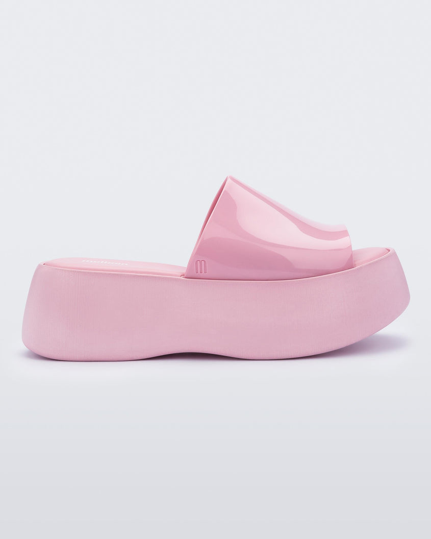 Side view of a pink Melissa Becky platform slide. 