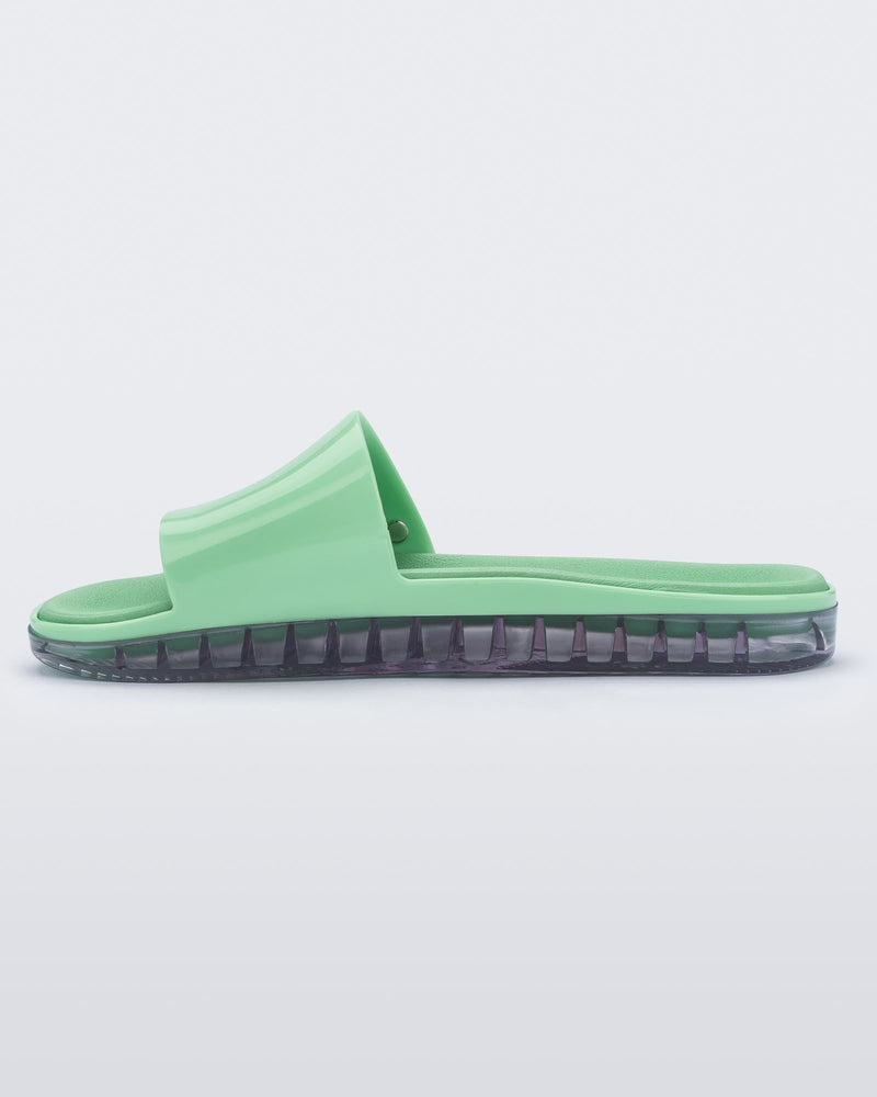 Inside view of a green Melissa Beach slide with clear sole. 