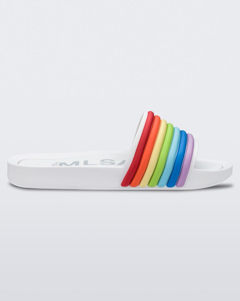 Side view of a white rainbow Melissa Rainbow Beach slide with a white sole and a rainbow top strap.