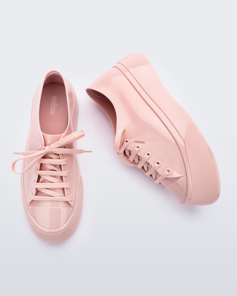 Top and side view of a pair of pink Drive sneaker