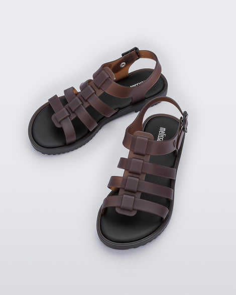Top view of a pair of clear brown Melissa Flox sandals with straps.