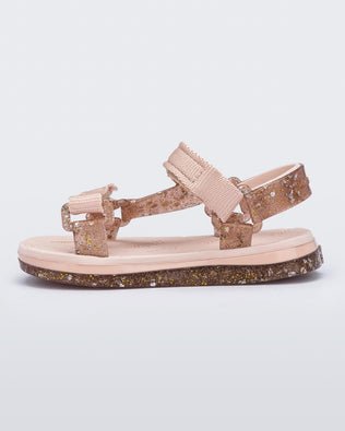 Side view of a pink Mini Melissa Papete sandal with glitter and pink straps.