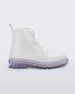 Outer side view of a pair of white/clear Melissa Coturno boot with a white base, laces and a clear sole.