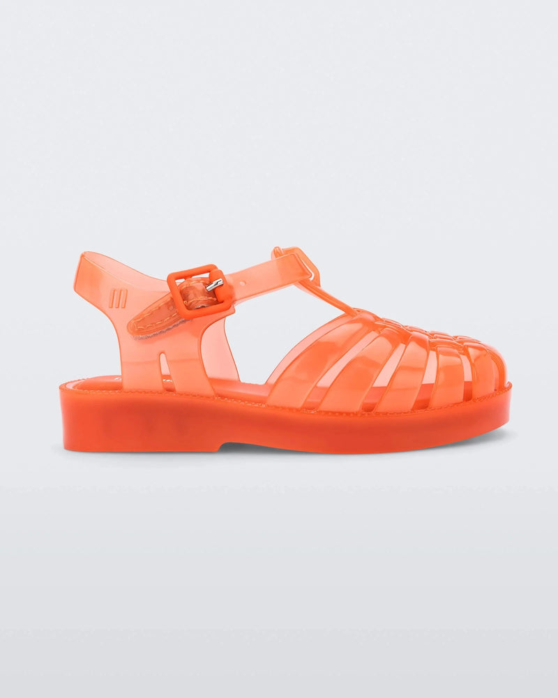 Side view of an orange Mini Melissa Possession sandal with several straps, a closed toe front and a back ankle strap.