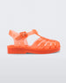 Side view of an orange Mini Melissa Possession sandal with several straps, a closed toe front and a back ankle strap.