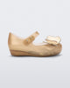 Side view of a gold Mini Melissa Ultragirl Butterfly flat with a top strap and two butterfly details on the toe.