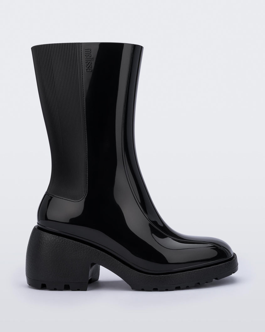 Side view of a Melissa Nancy heeled boot in black, with calf height shaft. 