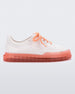 Side view of a white Melissa Classic sneaker with a white base, laces, orange sole and a melissa logo on the side.