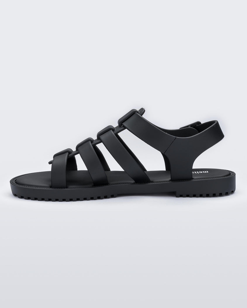 An inner side view of a black Melissa Flox sandal with straps.