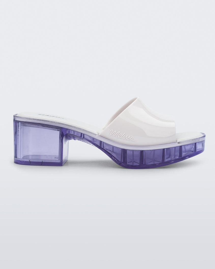 Side view of a Melissa Shape slide with clear heel and white wide strap 