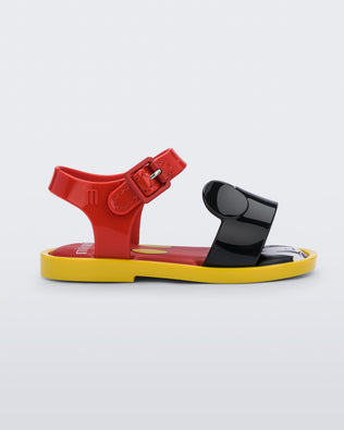 Side view of a red Mini Melissa Mar Sandal with mickey mouse insole, a red top strap, black bottom strap with mickey mouse ears on the top and a yellow sole.